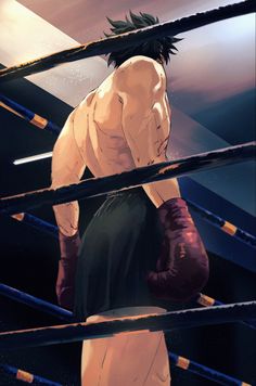 a man standing in the middle of a boxing ring with his hands on his knees