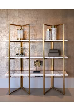 two shelves with books and vases on them in front of a wall mounted shelf