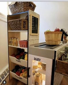 an open refrigerator sitting inside of a kitchen next to a basket of fruit and vegetables