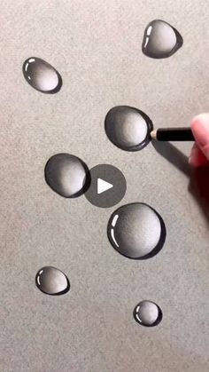 someone is drawing water droplets on the surface