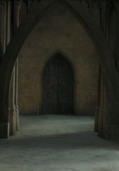 an archway in the middle of a building with stone floors and arches on both sides