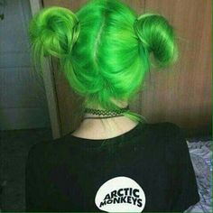 a woman with green hair is wearing a black shirt