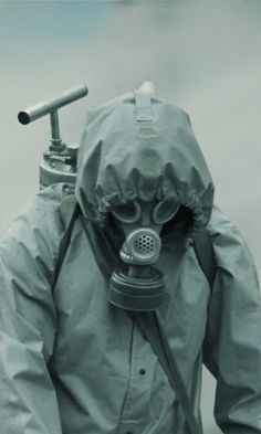 a man wearing a gas mask and raincoat