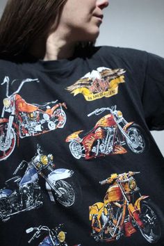 a woman wearing a black shirt with motorcycles on it