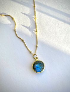 A delicate 14kt gold filled satellite necklace with a genuine blue labradorite pendant. A carefully selected and high quality labradorite crystal makes this necklace truly beautiful and one of a kind. The delicate and minimalist design of the necklace goes well with both casual and sophisticated looks. Perfect for a gift. ✦ MATERIALS ✦ 14kt gold filled satellite chain. Labradorite bezel pendant. LABRADORITE helps with reducing negativity, tempering impulsivity and recklessness, aiding in intuiti Gold Labradorite Everyday Jewelry, Everyday Gold Labradorite Jewelry, Dainty Labradorite Jewelry For Everyday, Gold Labradorite Round Jewelry, Gold Round Labradorite Jewelry, Yellow Gold Labradorite Round Jewelry, Gold Labradorite Jewelry With Birthstone, Gold Labradorite Birthstone Jewelry, Minimalist Round Labradorite Jewelry