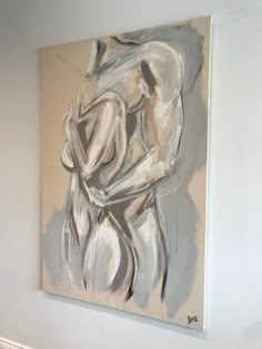 an abstract painting hangs on the wall next to a radiator