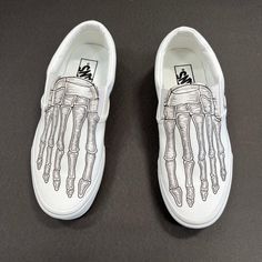 Look through your shoes and see your bones! These white Vans Slip Ons have been hand designed and custom printed to look like skeleton bones feet. We buy each pair of shoes BRAND NEW. Each pair is made to order, please make sure you put in the correct shoe size before you check out. The ink is permanent and will never come off, fade away, or peel off. Made in the USA. This price includes everything: shoes and artwork. Because the artwork is custom made for you, there are no exchanges or returns. Vans White Slip Ons, Vans Slip Ons, Custom Vans Shoes, Skeleton Bones, Vans White, White Vans, Vans Slip On, Custom Vans, White Slip