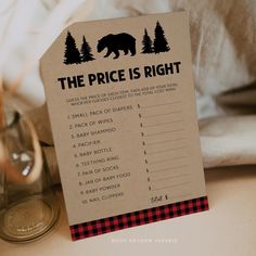 a price is right sign sitting on top of a table next to a glass bottle