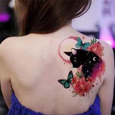 the back of a woman's shoulder with a cat and butterfly tattoo on it