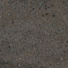 a close up view of the surface of a concrete slab with small rocks on it