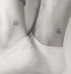 two people with matching tattoos on their feet, one has a sun and the other has a moon