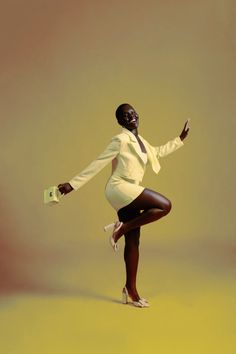 a woman in a white shirt and black skirt is posing with her arms out to the side