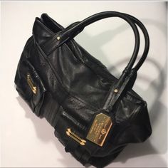 Large Leather Bag Black With Gold Tone Hardware Used In Good Condition Without Holes Or Stains Or Foul Odors. The Two Straps Shows Signs Of Normal Wear. Straps Are 7 Inches Long And The Purse Size Is 16x10x7. Inside Have 1 Zipper Pocket And Two Slip Pockets And One Large Snap Pocket. Two Pockets On The Outside. Magnetic Closure Designer Office Bags With Brass Hardware, Designer Office Bag With Brass Hardware, Black Leather Satchel With Brass Hardware, Elegant Black Bag With Brass Hardware, Elegant Black Bags With Brass Hardware, Elegant Black Shoulder Bag With Brass Hardware, Black Travel Bag With Brass Hardware, Black Satchel With Brass Hardware For Work, Black Business Bags With Brass Hardware