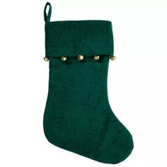 a green christmas stocking with gold studs on the top and bottom, hanging from a rope