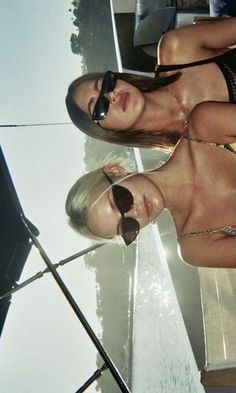 two beautiful women in bikinis standing next to each other