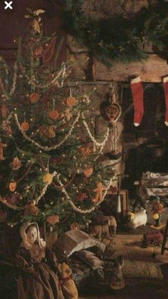 a christmas tree with stockings hanging from it's branches in front of a fireplace