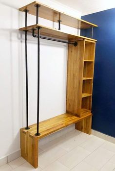 a wooden shelf sitting next to a blue wall