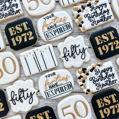 50th birthday cookies decorated with black and white icing are on display for guests to enjoy