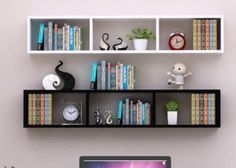 a laptop computer sitting on top of a desk in front of a bookshelf