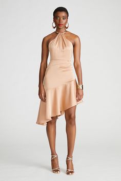 Embrace sun-drenched elegance in the Beverly Dress, a tan beige halter neck mini adorned with necklace hardware and a flounce skirt. This versatile piece effortlessly transitions from day to night.  Asymmetric Silhouette Halter Neck Sleeveless Asymmetric Length REF: 10112007 Beige Satin Dress, High Low Cocktail Dress, Satin Halter Dress, Flounce Skirt, Black Halter Dress, Dress Halter, Flare Mini Dress, Knitwear Dress, Satin Mini Dress