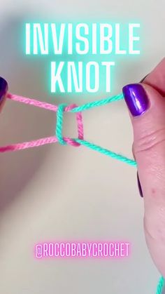 a person holding two pink and blue twine with the words invisible knot on it