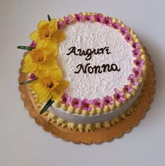 there is a cake that has flowers on it and the words agoura noma written in black