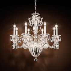 a crystal chandelier hanging from the ceiling with five lights on each arm and one light in the middle