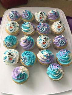 there are many cupcakes on the tray with frosting and icing designs