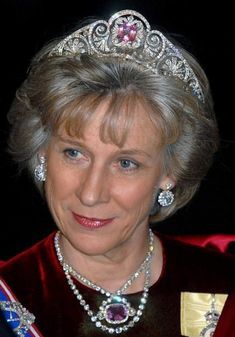 an older woman wearing a tiara and smiling at the camera