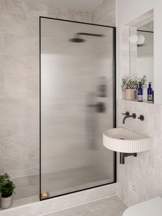 a bathroom with a sink, mirror and shower stall