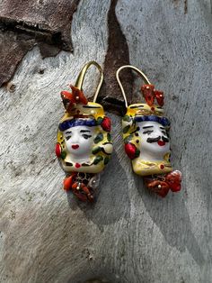 Sicilian earrings with hand-painted ceramic with fine gold touches Mounted in brass with Mediterranean coral and river pearls Hand Painted Gold Dangle Jewelry, Gold Hand Painted Dangle Jewelry, Unique Hand Painted Earrings For Gift, Yellow Gold Enamel Earrings As Gift, Handmade Enamel Gold Jewelry, Handmade Gold Enamel Earrings, Enamel Earrings With Artistic Design For Gift, Handmade Yellow Gold Artisan Earrings, Single Enamel Drop Earring