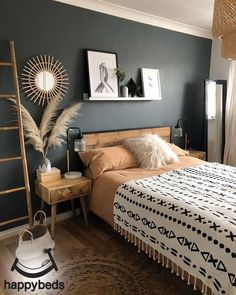 a bed room with a neatly made bed and pictures on the wall