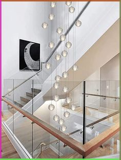 a staircase with glass railings and lots of lights