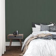 a bedroom with green walls and white bedding