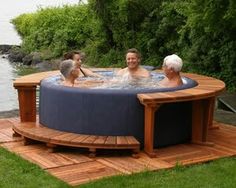 an outdoor hot tub with three people in it