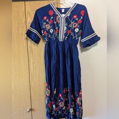 New With Tags, Beautiful Embroidered Floral Pattern Dress. Navy Blue Size Small. Embroidered Blue Maxi Dress For Summer, Blue Floral Embroidery Midi Dress, Blue V-neck Dress With Embroidered Hem, Blue Floral Print Embroidered Summer Dress, Summer Blue Embroidered Floral Print Dress, Spring Embroidered Blue Maxi Dress, Spring Blue Embroidered Maxi Dress, Blue Embroidered Maxi Dress For Spring, Blue Embroidered Maxi Dress For Summer