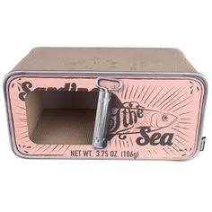 a pink and silver metal box with an open door on the inside that says life's a sea