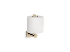 the toilet paper holder is made from brass and has a white roll hanging on it