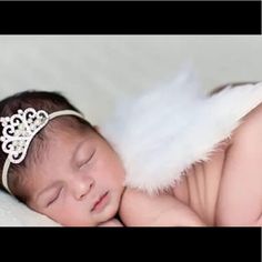 a baby is wearing a tiara and sleeping