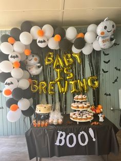 a baby is brewing party with balloons and desserts