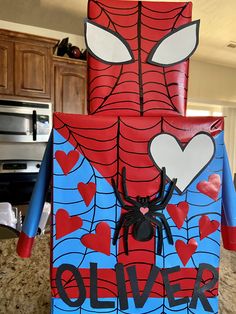 a homemade spiderman costume made out of toilet paper with hearts on his chest and eyes