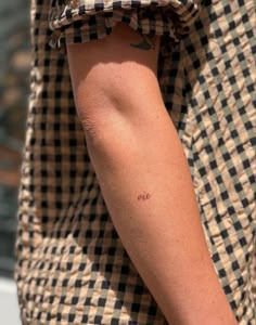 a person with a small tattoo on their arm