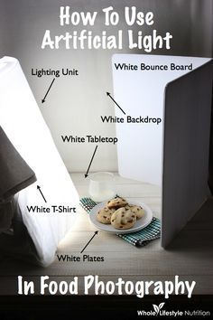 an open laptop computer sitting on top of a white table next to cookies and milk