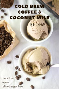 two bowls filled with ice cream and coffee beans on top of a white tablecloth