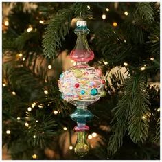 a glass ornament hanging from a christmas tree