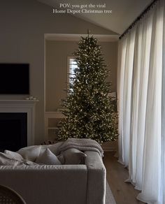 a living room with a christmas tree in the corner