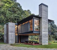 the modern house is surrounded by trees and grass