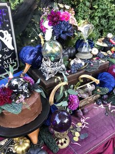 a table topped with lots of different types of cakes and halloween decorations on top of it