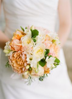 a bride holding a bouquet of flowers in her hand