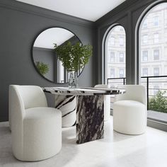 an elegant dining room with grey walls and marble table surrounded by white chairs in front of large arched windows